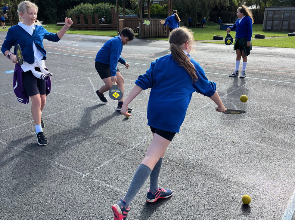 Children playing Street Racket in a school playground